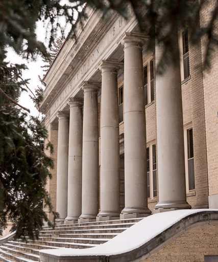 The front of the admin building as seen from the side with a light dusting of snow.